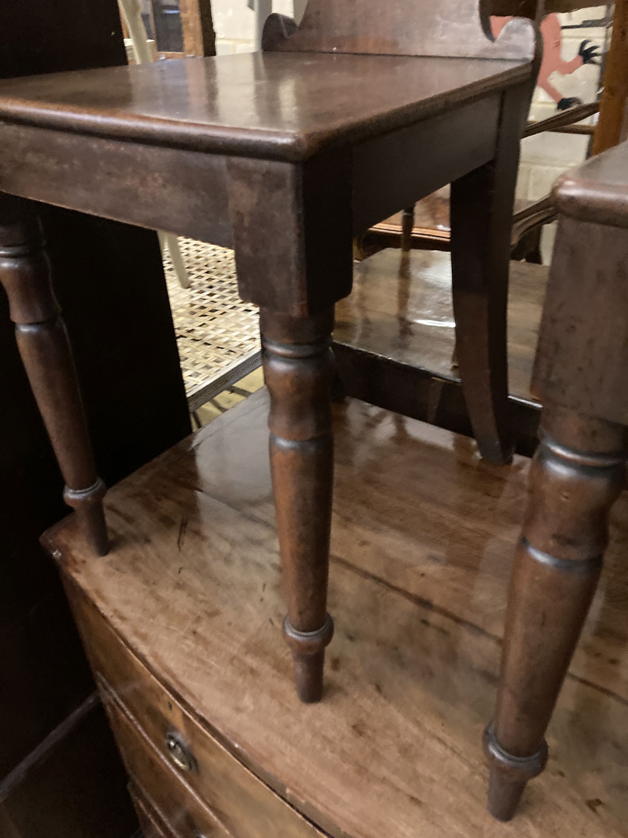 A pair of Victorian mahogany hall chairs